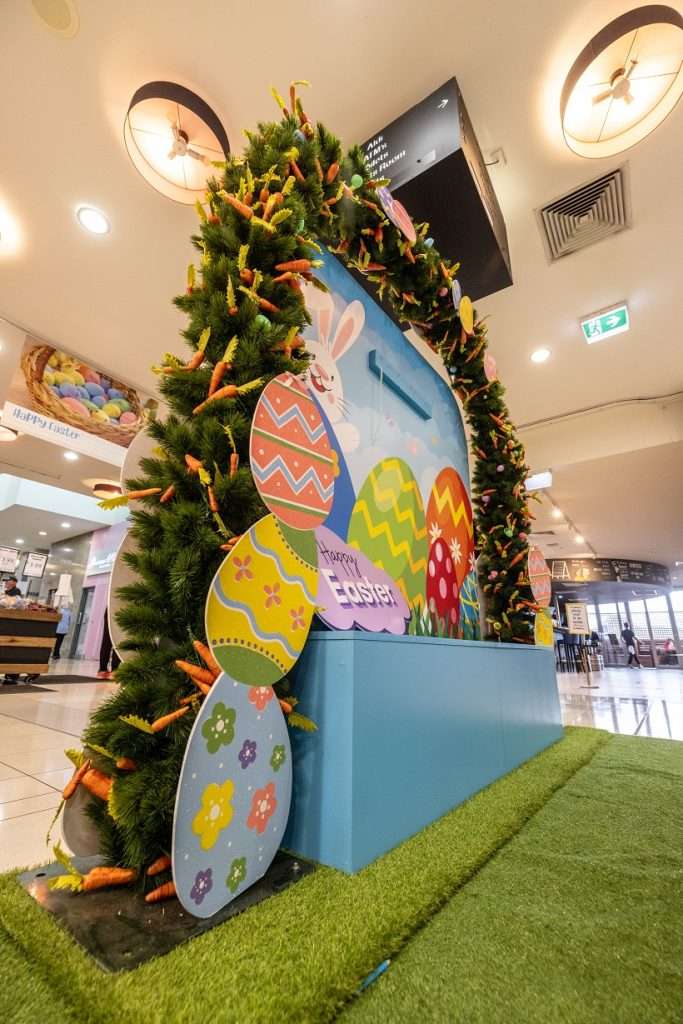 Easter seat with carrot garlands and egg artwork on grass