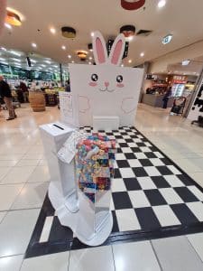 Easter Bunny square backdrop, with checkered floor and box of Easter eggs