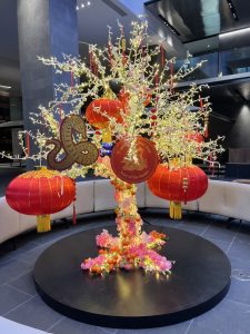 A large LED Cherry blossom tree decorated in red chinese lanterns, cherry blossom and zodiac snake design
