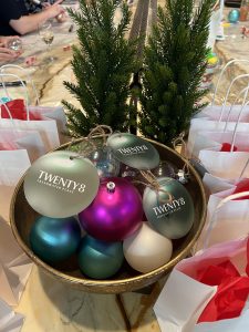 Christmas baubles in a bowl with a label for 28 Freshwater place. Paper bags surround the bowl