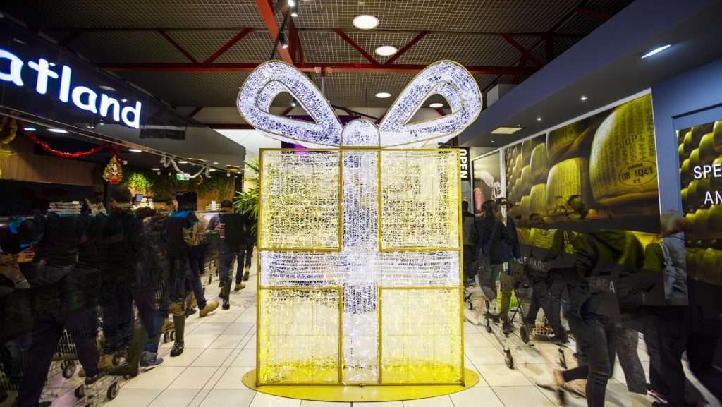 Large LED Giftbox in a shopping centre. The giftbox is gold with silver bow and ribbon.