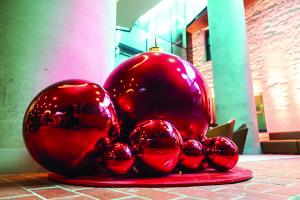 A giant red metallic bauble display at a commercial space in Melbourne.