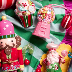 Candy Joy Christmas decorating theme with lolly dispensers, colourful nutcrackers and candy christmas decorations on a green stripe fabric
