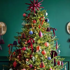 Christmas tree decorated in trend decorations with teal background