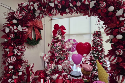 View of Christmas themed showroom with Candy decorated tree and arch with fiberglass hearts and candy pieces
