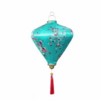 A blue fabric floral lantern with decorative tassel, inspired by floral tributes used in Lunar New Year celebrations.