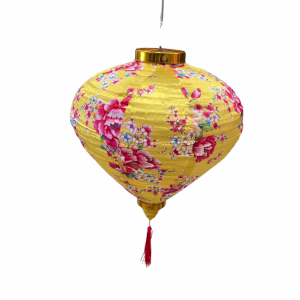 Lunar lantern balloon in bright yellow fabric with floral patterns and a red tassel.