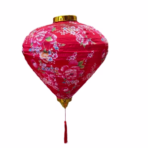 Lunar lantern balloon in deep pink fabric with floral patterns and a red tassel.
