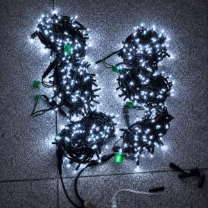 Multiple sets of illuminated cool white commercial LED lights arranged on a stone floor